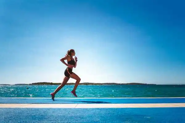 Woman running showing strong leg muscle Oakham